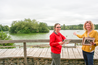 Nature Discovery Centre commercial manager Tanya Alexander and visitor centre manager Jo Thrussell in front of the lake island ahead of its margin enhancements in 2022. Picture: Pete Hughes