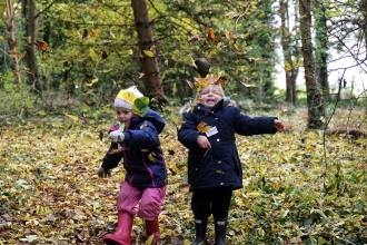 children playing with leaves