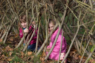 children in a willow tunnel