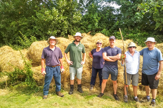 Hedgerow Havens volunteers making hay in a field near the village of Weedon. Picture: Marcus Militello