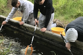 Secondary school biology students pond dipping at College Lake.