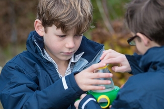 2 boys holding a bug viewer