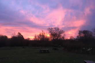 The sun rises dramatically - lots of purples and oranges - over our SCEEC reserve