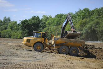 A digger excavating soil in the countryside. Picture: David Tipling/ 2020Vision