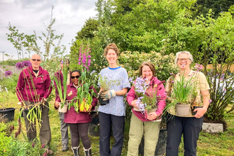 Katie Horgan from BBOWT (right) with staff from Lindengate charity and some of the 700 plants from BBOWT's Wilder Spaces garden at RHS Malvern Spring Festival