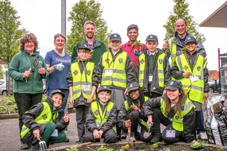 Pupils from Southcote Primary School in Reading help plant flowers in Coronation Square as part of BBOWT's Nextdoor Nature project.