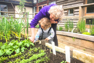 BBOWT Learning Officer Anne Jackson with a young visitor in the wildlife garden at Sutton Courtenay Environmental Education Centre (SCEEC)