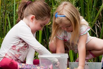 Children and mothers pond dipping. 