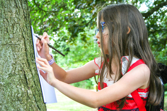 Amelia Webb does a bark rubbing as part of BBOWT's Engaging with Nature project with The Autism Group in Maidenhead