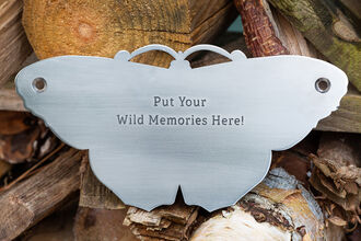 A metal plaque in the shape of a butterfly that can be engraved with a personal, commemorative message