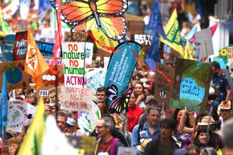 A group of people with signs in support of nature
