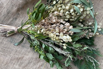 a bouquet of white flowers against a hessian background