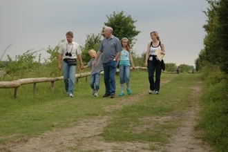 a family walking down a path at College Lake