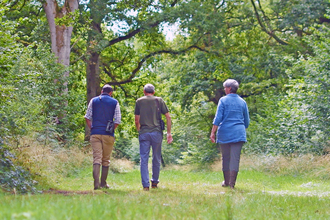 Estelle Bailey MBE, BBOWT CEO walking with colleagues through Hamgreen Wood