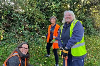 Three ladies outside wearing hi-vis jackets
