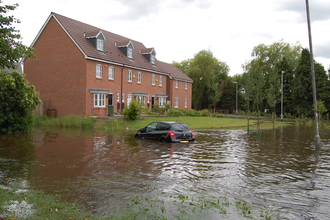 Flooding of cars and houses caused by bad floodplain management