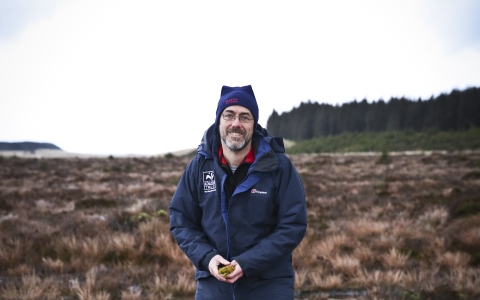 Duncan standing on a wetland