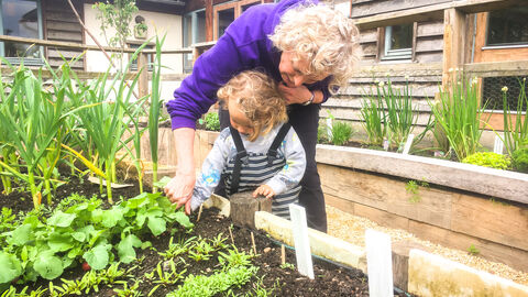 BBOWT Learning Officer Anne Jackson with a young visitor in the wildlife garden at Sutton Courtenay Environmental Education Centre (SCEEC)