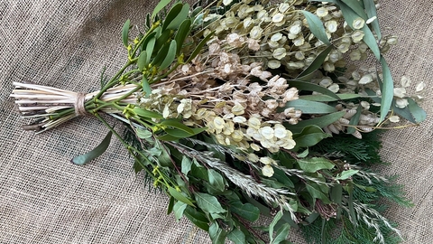 a bouquet of white flowers against a hessian background