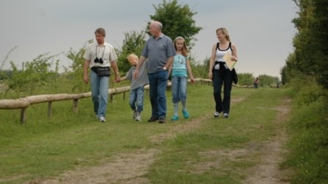 a family walking down a path at College Lake