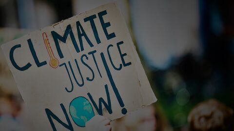 Sign reading climate justice now