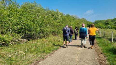 A group take a relaxed walk around site 