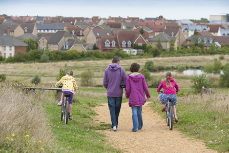 Image of people walking near a town by Paul Hobson