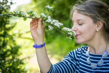 Woman smelling blossom