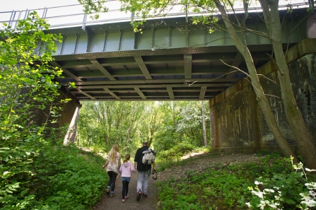 Family walking under a bridge