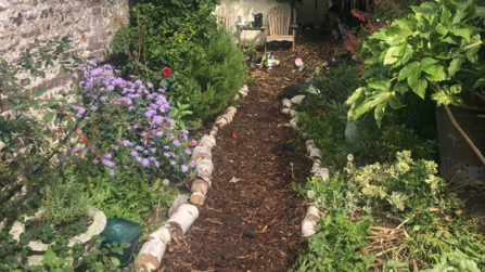 Garden path with two flower filled flowerbeds