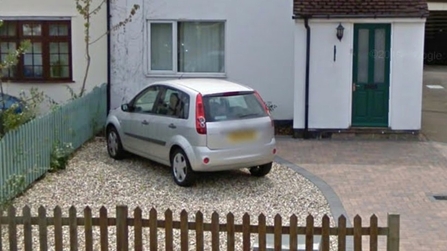 Front garden with gravel and paving stones, and car parked