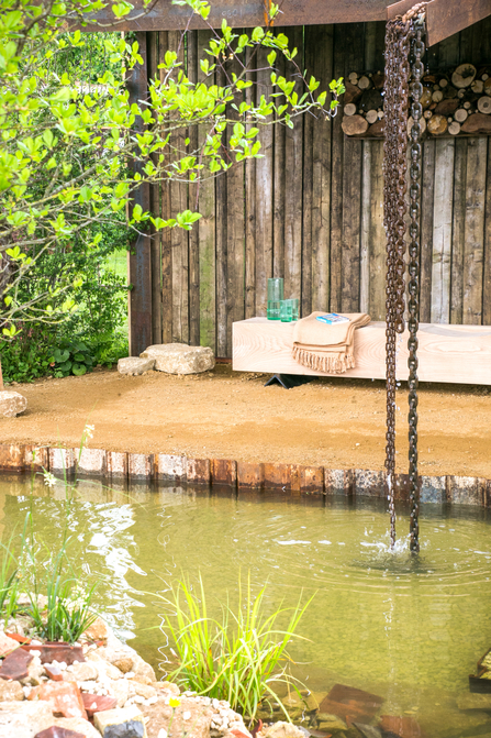 A waterfall at BBOWT and the Wildlife Trusts' garden at the 2023 RHS Malvern Spring Festival, created with Oxford Garden Design, Charlie Luxton and Future Nature.