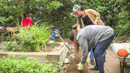 Members of the Slough Ujala Foundation community planting a garden at the Manor Park Pavilion