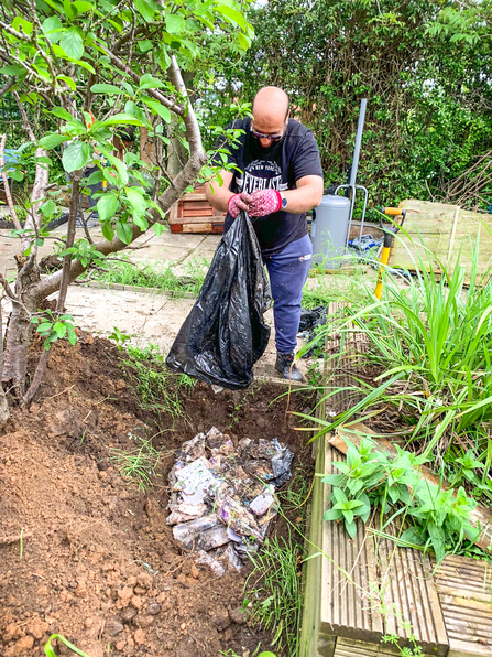 Arshad Mehmood Janjua burying sacred literature in the Ujala Foundation community garden at the Manor Park Pavilion in Slough