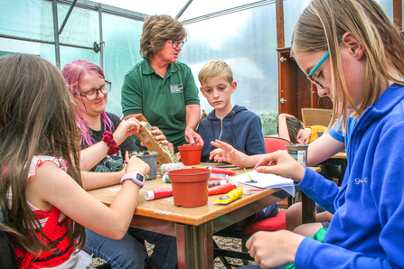 Children and teenagers making bee hotels as part of BBOWT's Engaging with Nature project with The Autism Group in Maidenhead.