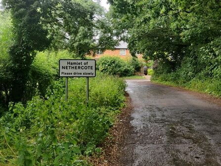 Road sign on a grassy verge saying Welcome to Nethercote