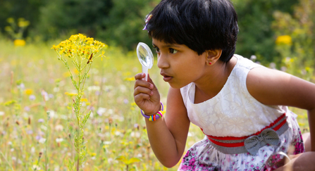 Girl looking at caterpillar