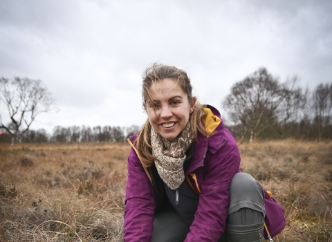 Elspeth holding soil in a wetland