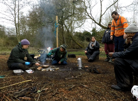 Engaging with Nature participants cooking around a fire