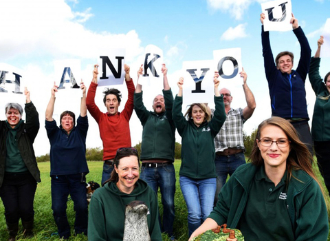 Group of people holding up thank you sign